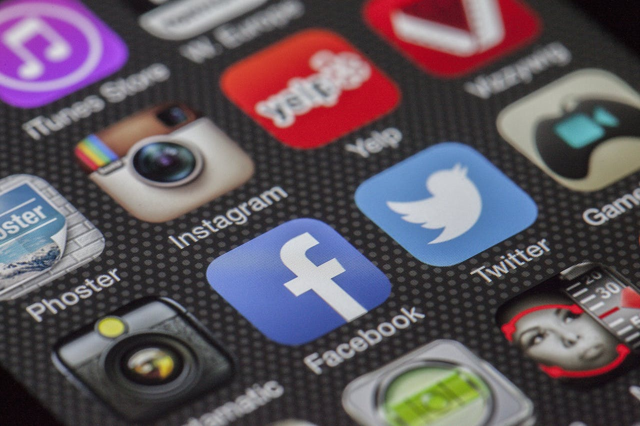 Services Close-up image of various social media app icons on a smartphone screen.